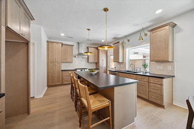 The deluxe kitchen includes rich cabinetry, tons o
