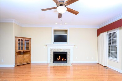 The great room has crown molding, gas fireplace with a granite tile surround, gorgeous hardwoods.
