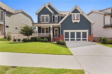 Craftsman house with brick siding, a porch, driveway, a front yard, and an attached garage