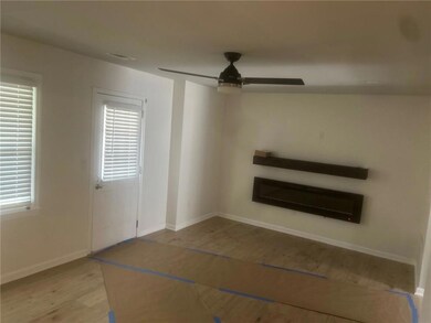 Unfurnished living room featuring baseboards, ceil