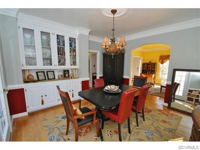 Your dining room features hardwood flooring, glass