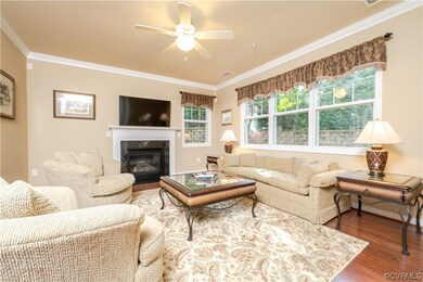 Hardwood floored living room featuring a fireplace