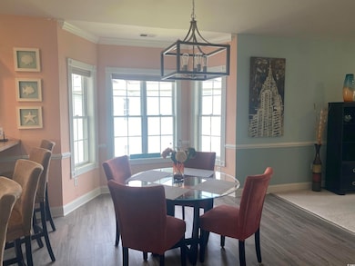 Dining area with crown molding, hardwood / wood-st