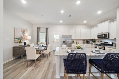 The kitchen and breakfast area seamlessly connect, for added convenience when enjoying family time or hosting.