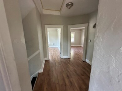 Hallway featuring dark wood-type flooring