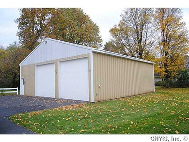 Exterior Front. Oversized (40 x 40) garage with el