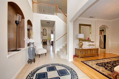 Welcome inside. The dining room to the right is serving as a packing station right now. You can still see the wood floors, crown molding and opening to the kitchen.