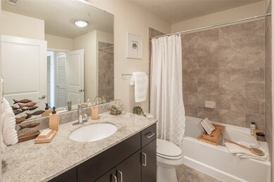 The ensuite bathroom features a vanity and a shower/tub combo!
