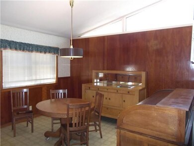 Eating area by kitchen. Note vaulted ceilings thru
