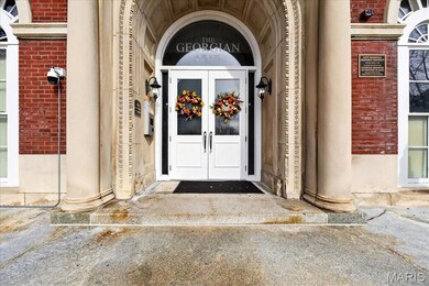 Property entrance featuring brick siding and french doors