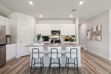 Kitchen in the Emmy II home plan by Trophy Signature Homes - REPRESENTATIVE PHOTO