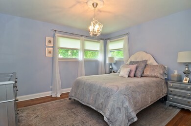 Peaceful master bedroom with hardwood floors and l