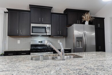 The kitchen has a large island with.  granite coun
