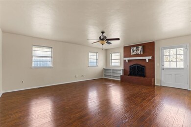 Unfurnished living room featuring dark wood-type f
