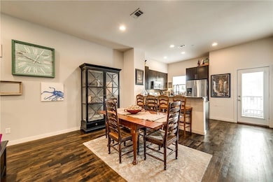 Dining space featuring dark wood-style floors and recessed lighting