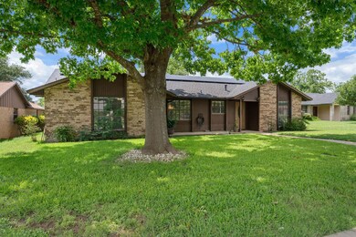 Mid-century home with brick siding, solar panels,