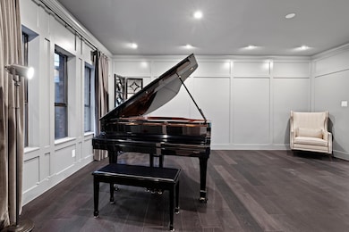 Living area featuring a decorative wall, dark woo