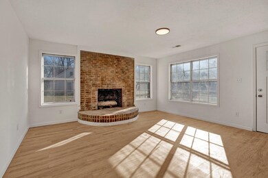 Unfurnished living room with brick wall, a firepla