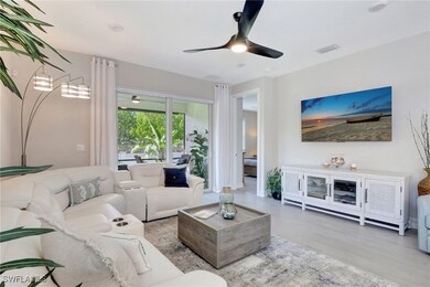 Living room featuring ceiling fan and light hardwo