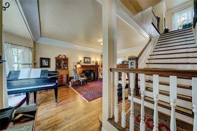 Front living area with wide bay window and firepla