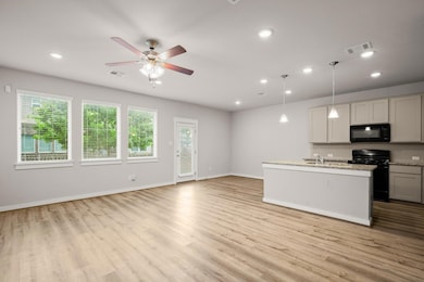 Kitchen featuring black appliances, plenty of nat