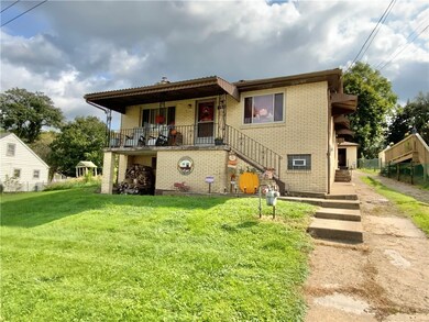 Front of house with cement driveway to 2 car garag