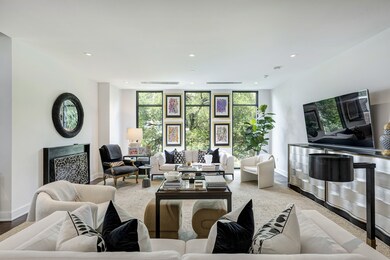 The large living room has three floor-to-ceiling w