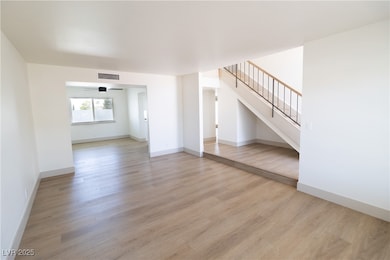 Unfurnished living room featuring light wood-style