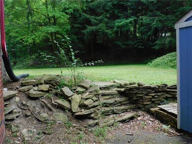 Beautiful stone entry into a tabletop backyard.