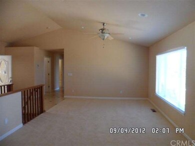 Living room w/ceilingfan, entry to left.