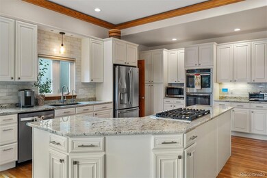 Well-appointed kitchen with ample prep and storage space, a new tile backsplash, stainless steel appliances, and double ovens.