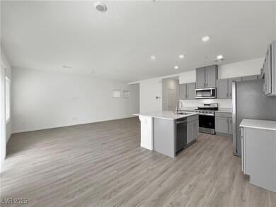 Kitchen featuring gray cabinetry, an island with s
