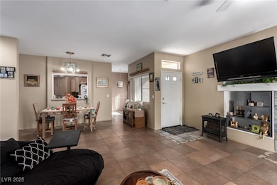 Tiled living room with a chandelier