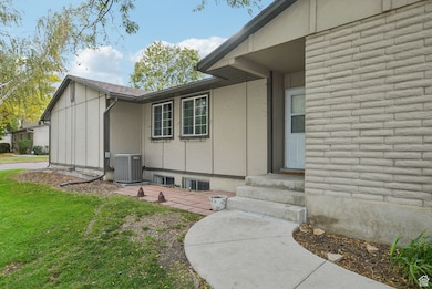 View of exterior entry featuring a yard and a patio