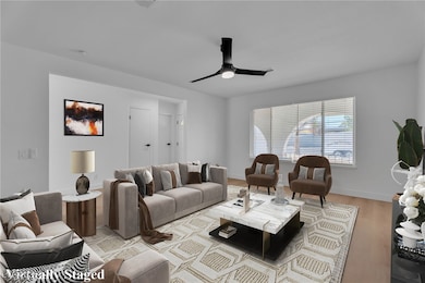 Living area featuring wood finished floors and a ceiling fan
