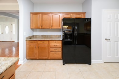 Kitchen featuring black fridge with ice dispenser,