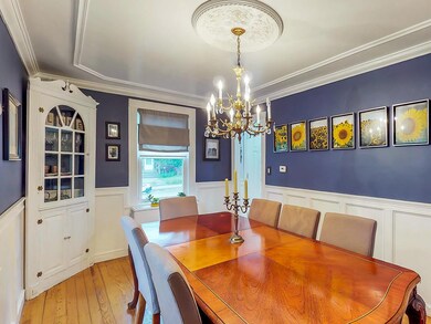 Stunning dining room with detailed moldings and ch