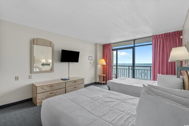 Bedroom featuring access to exterior, carpet floors, floor to ceiling windows, and a textured ceiling