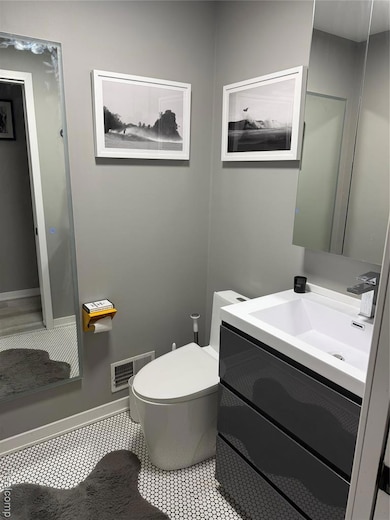 Bathroom with vanity and baseboards