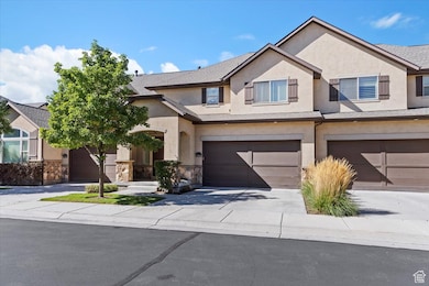 Traditional home with concrete driveway, stucco siding, and a garage