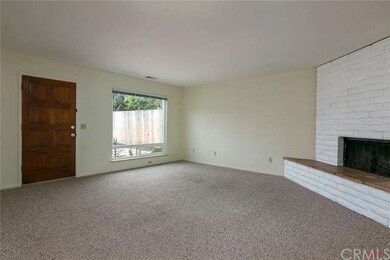 Living room with large picture window and wood bur