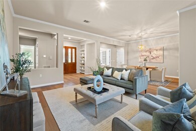 Living room featuring ornamental molding, wood fi