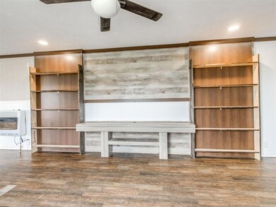 Unfurnished living room featuring heating unit, ceiling fan, wood finished floors, and recessed lighting