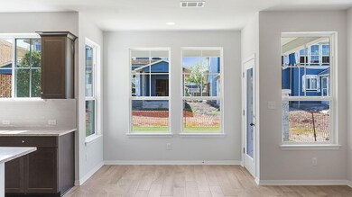 Doorway featuring light wood-type flooring, baseb