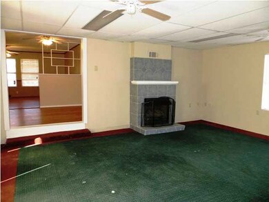Huge family room offers a wood burning fireplace,