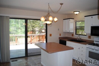 sliding door to large deck off kitchen with eat at