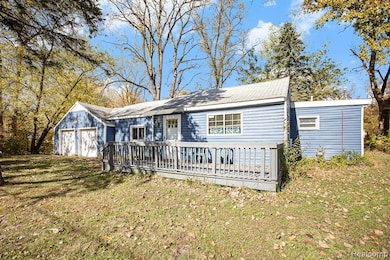 View of front of house featuring a front lawn and a wooden deck