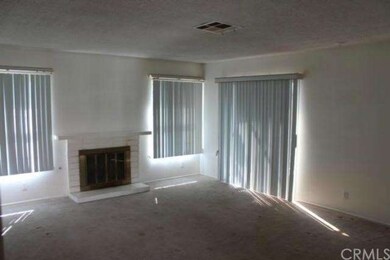 Living Room w/ Fireplace and Door to Sunroom