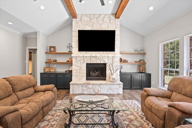 Living room featuring vaulted ceiling with beams, 