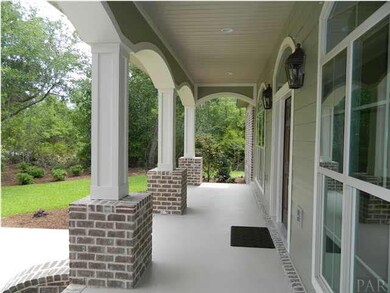 Front entrance has covered porch and decorative front door.